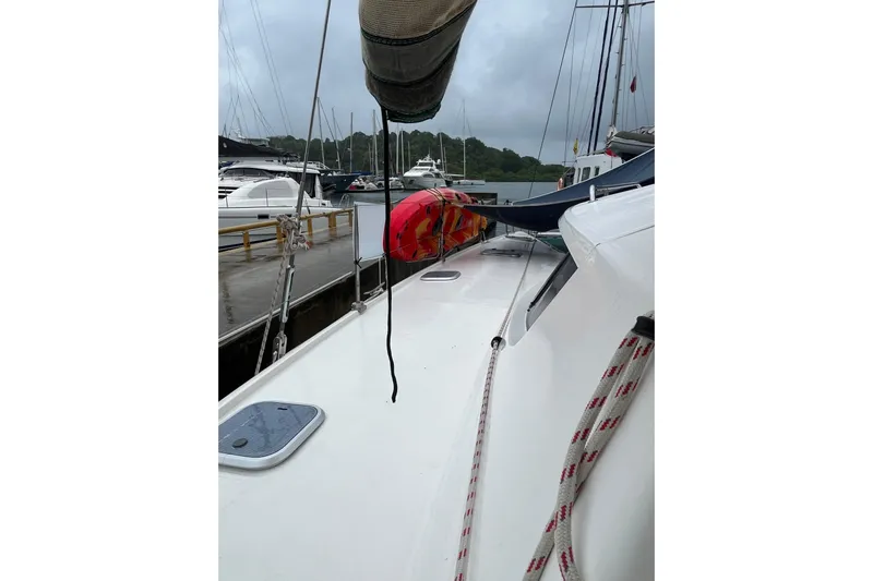 Nikita 1 Yacht Photos Pics 2004 Fountaine Pajot Bahia 46 catamaran docked at marina, overcast sky.