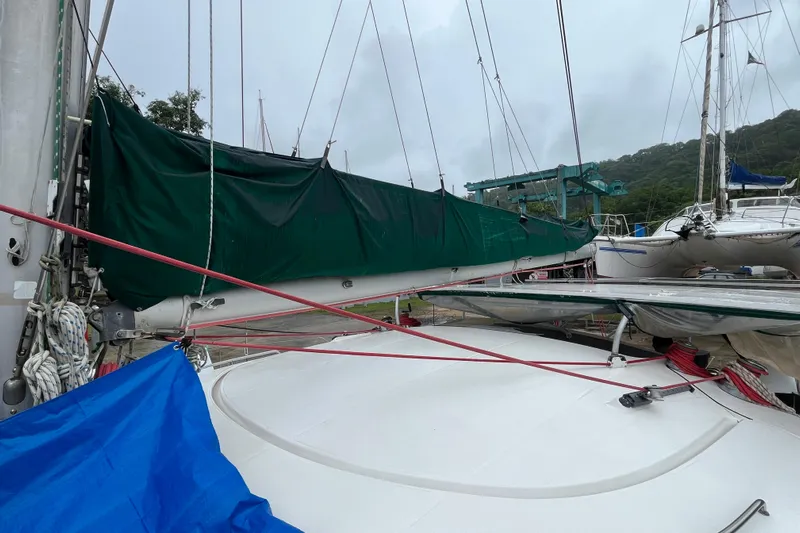 Nikita 1 Yacht Photos Pics 2004 Fountaine Pajot Bahia 46 catamaran with green sail cover, docked outdoors.