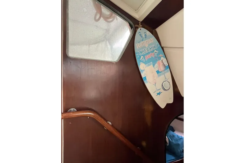 Nikita 1 Yacht Photos Pics Interior of 2004 Fountaine Pajot Bahia 46 with summer beach party sign.