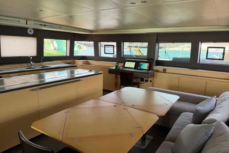 Sona 1 Yacht Photos Pics Luxurious interior of 2019 Lagoon 630 MY yacht with modern kitchen and seating area.