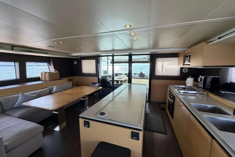 Sona 1 Yacht Photos Pics Luxurious interior of 2019 Lagoon 630 MY yacht with modern kitchen and seating area.