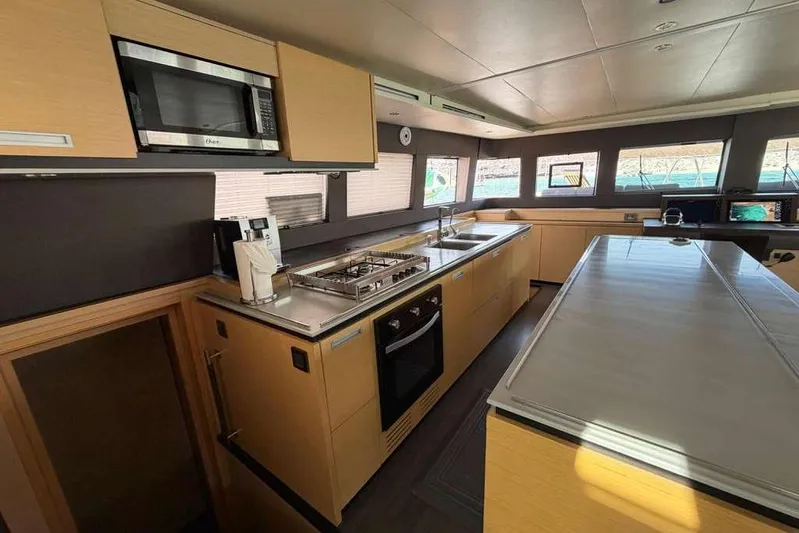 Sona 1 Yacht Photos Pics Luxurious kitchen interior of 2019 Lagoon 630 MY yacht with modern appliances.