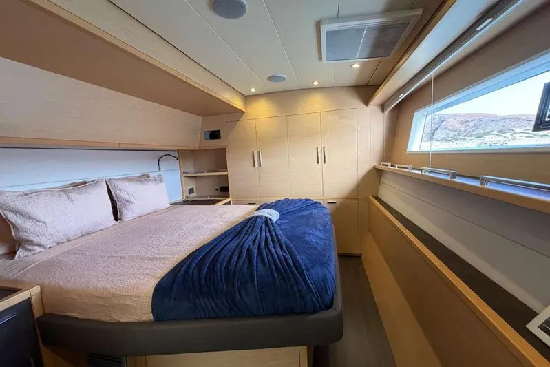 Sona 1 Yacht Photos Pics Luxurious cabin interior of 2019 Lagoon 630 MY yacht with cozy bed and modern design.