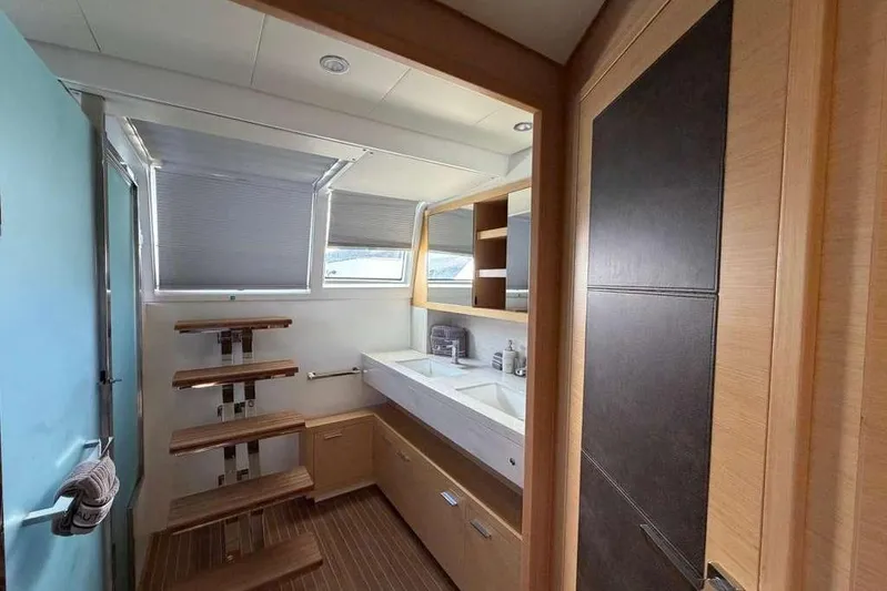 Sona 1 Yacht Photos Pics Luxurious bathroom interior of 2019 Lagoon 630 MY yacht with modern fixtures and wooden accents.