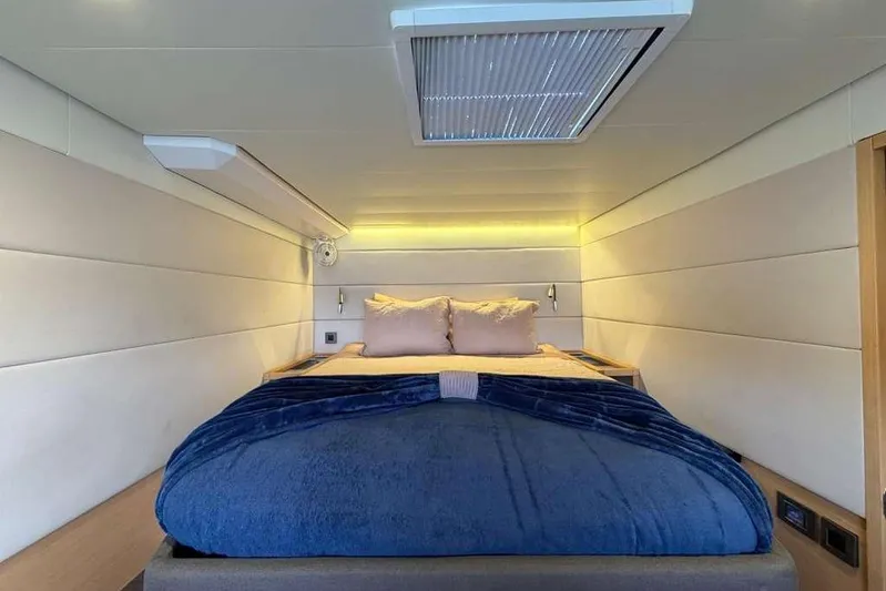 Sona 1 Yacht Photos Pics Luxurious bedroom interior of 2019 Lagoon 630 MY yacht with cozy bedding.