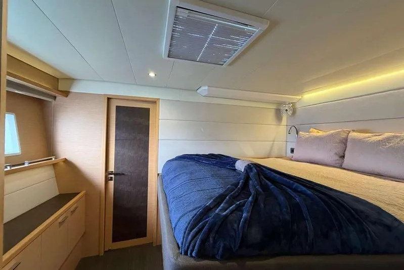 Sona 1 Yacht Photos Pics Luxurious cabin interior of 2019 Lagoon 630 MY yacht with cozy bedding.