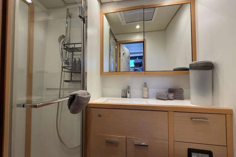 Sona 1 Yacht Photos Pics Luxurious bathroom in 2019 Lagoon 630 MY yacht with modern fixtures and wooden cabinetry.