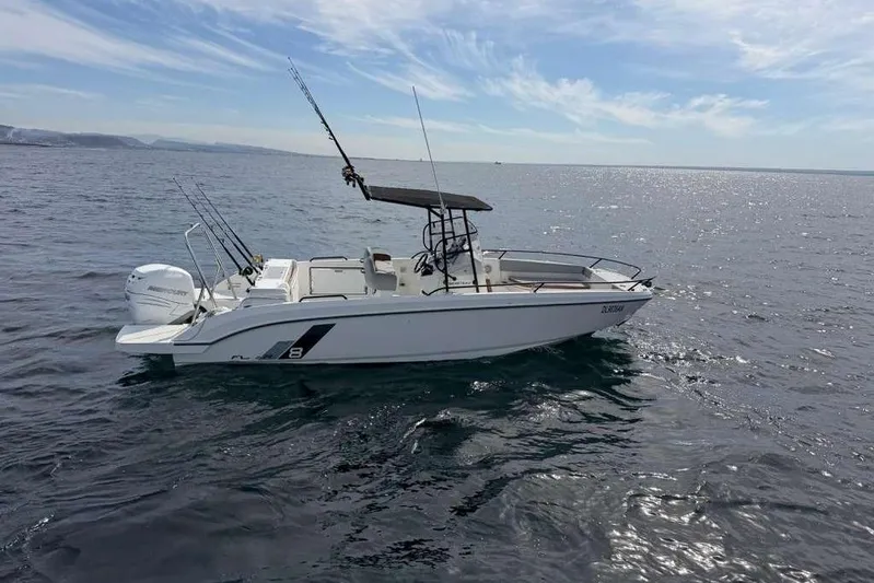 Sona 1 Yacht Photos Pics A fishing boat on open water under a clear sky, featuring multiple fishing rods.