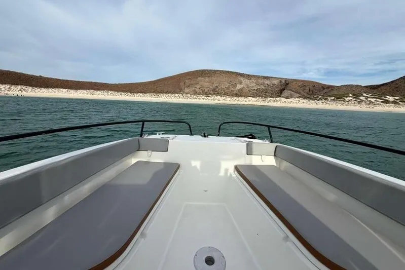 Sona 1 Yacht Photos Pics 2019 Lagoon 630 MY yacht cruising near a scenic coastline.