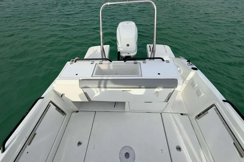 Sona 1 Yacht Photos Pics 2019 Lagoon 630 MY yacht deck with motor, on calm green water.