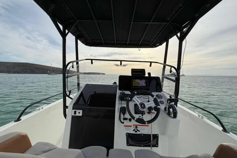 Sona 1 Yacht Photos Pics Cockpit view of 2019 Lagoon 630 MY yacht on calm waters at sunset.
