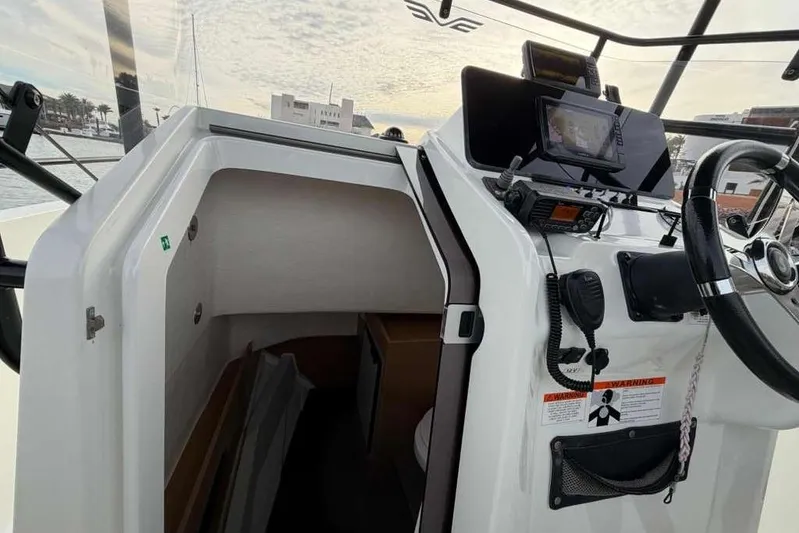 Sona 1 Yacht Photos Pics Cockpit view of 2019 Lagoon 630 MY yacht with navigation equipment and cabin entrance.