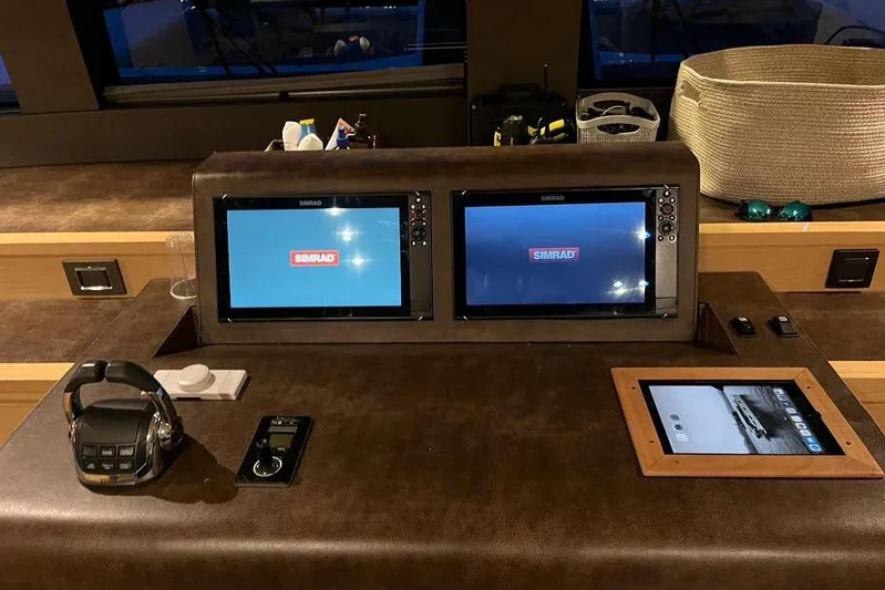 Sona 1 Yacht Photos Pics Control panel of 2019 Lagoon 630 MY yacht with Simrad displays and navigation equipment.