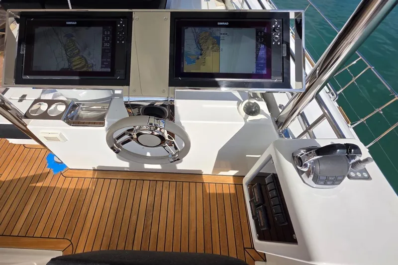 Sona 1 Yacht Photos Pics Helm station of 2019 Lagoon 630 MY yacht with dual navigation screens and controls.