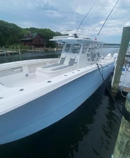  Yacht Photos Pics 2023 Invincible 46 Catamaran docked, showcasing sleek design and spacious deck.