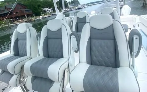  Yacht Photos Pics 2023 Invincible 46 Catamaran Plus Quad Axle Trailer with luxurious seating on a scenic waterfront.