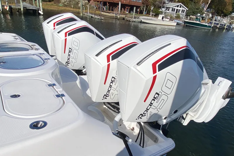  Yacht Photos Pics 2023 Invincible 46 Catamaran with powerful quad outboard engines on water.