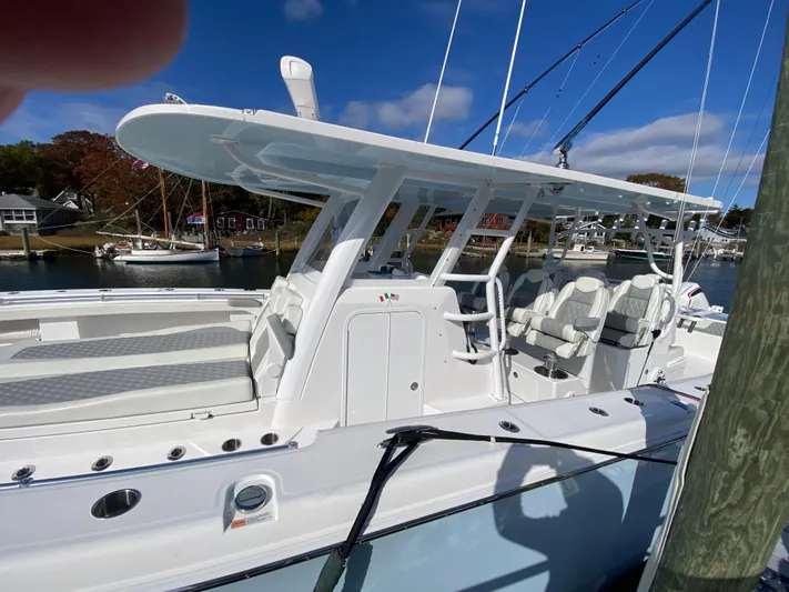  Yacht Photos Pics 2023 Invincible 46 Catamaran Plus Quad Axle Trailer docked, showcasing sleek design and spacious seating.