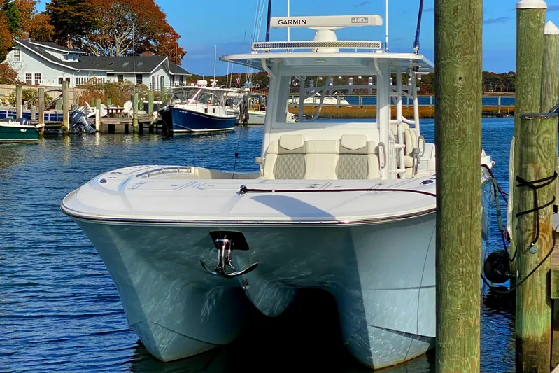  Yacht Photos Pics 2023 Invincible 46 Catamaran docked, showcasing sleek design and advanced features.