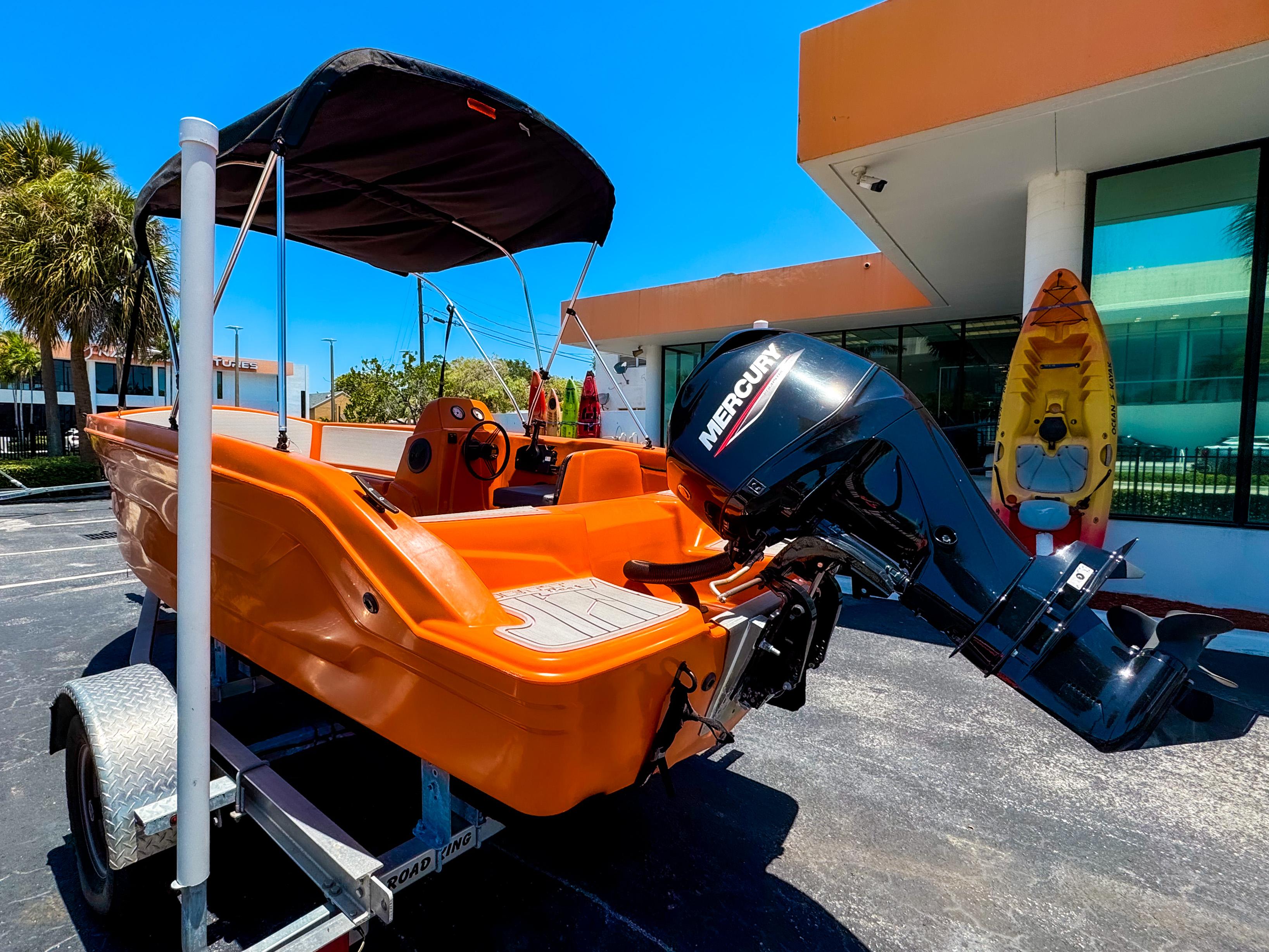 2024 Vision Marine Technologies Phantom boat with Mercury engine, parked on a trailer.