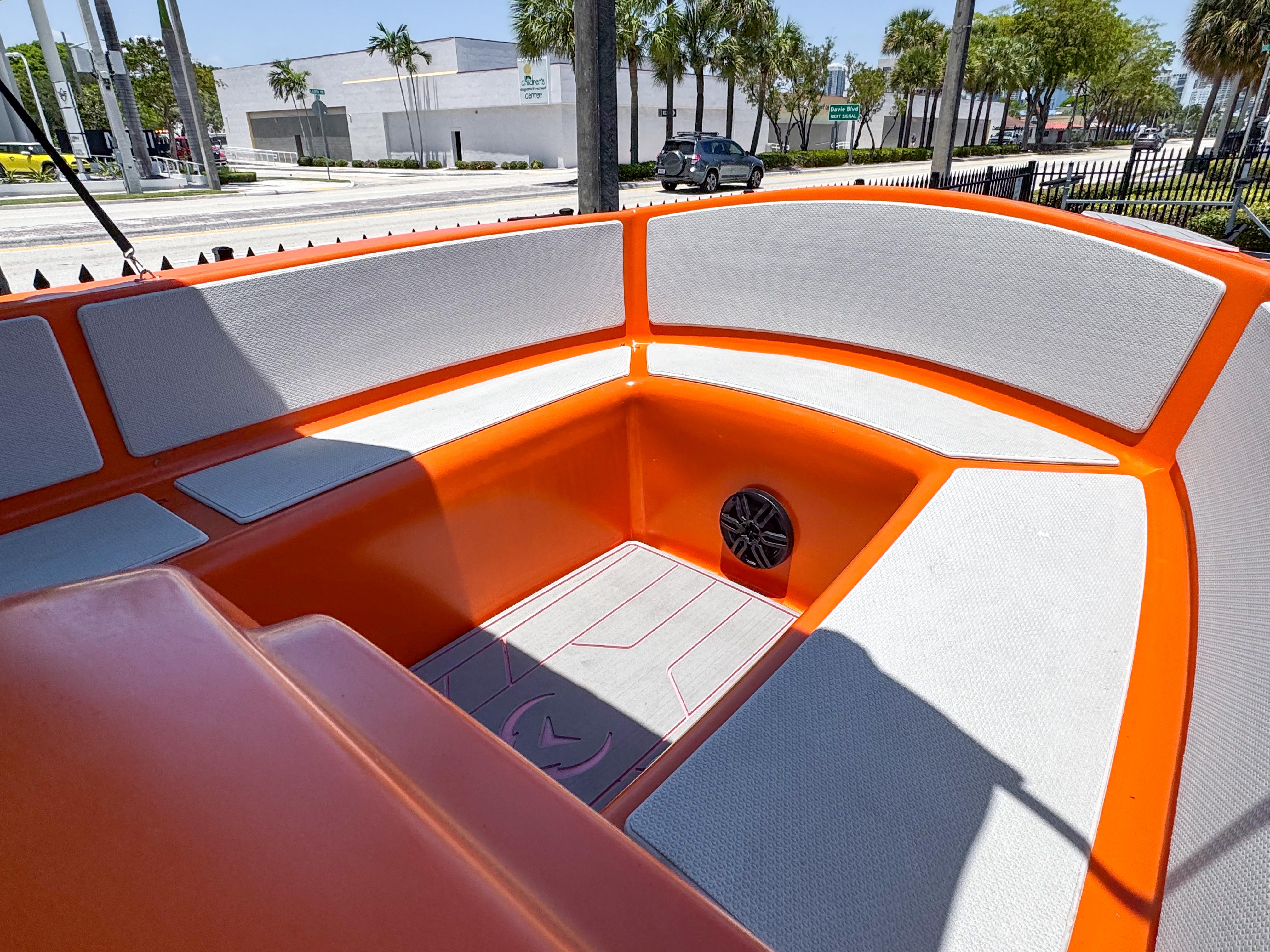 2024 Vision Marine Technologies Phantom boat interior with orange and gray seating.
