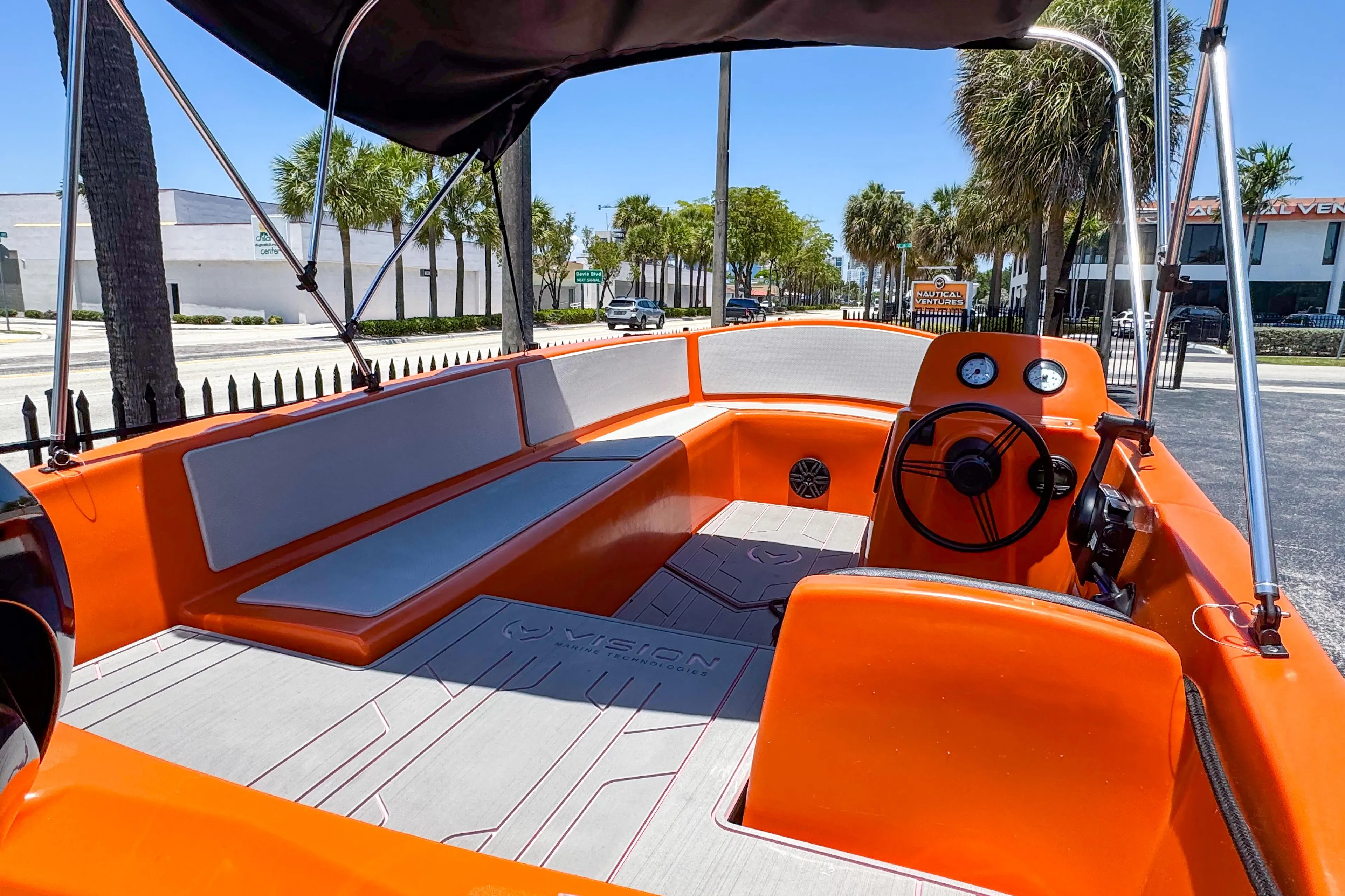 2024 Vision Marine Technologies Phantom boat with vibrant orange interior and modern design.