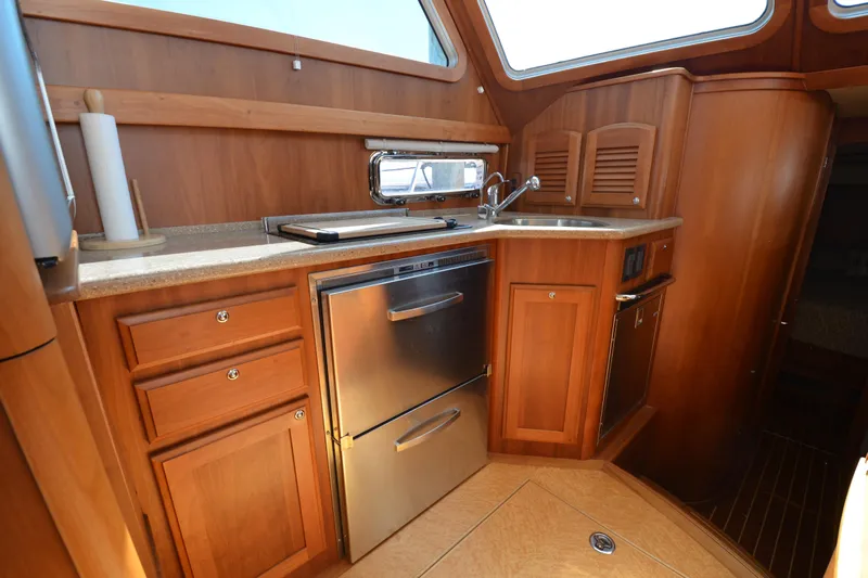 Sea Pilot Yacht Photos Pics Luxurious 2014 Sabre 42 Salon Express yacht kitchen with wood cabinetry and stainless steel appliances.
