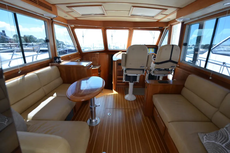 Sea Pilot Yacht Photos Pics 2014 Sabre 42 Salon Express interior with luxurious seating and helm, featuring wood accents.