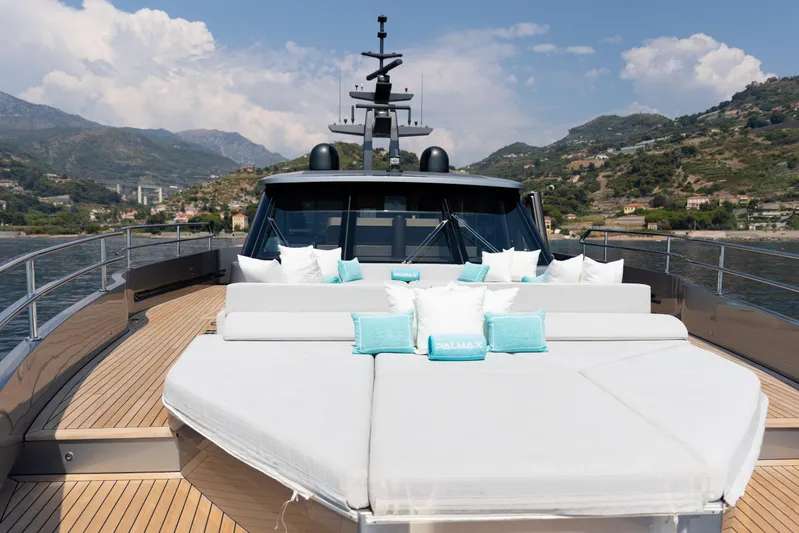 Palmax Yacht Photos Pics Luxurious 2022 Azimut Magellano 30M yacht deck with plush seating and scenic coastal backdrop.