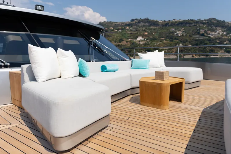 Palmax Yacht Photos Pics Luxurious deck seating on 2022 Azimut Magellano 30M yacht with scenic coastal view.