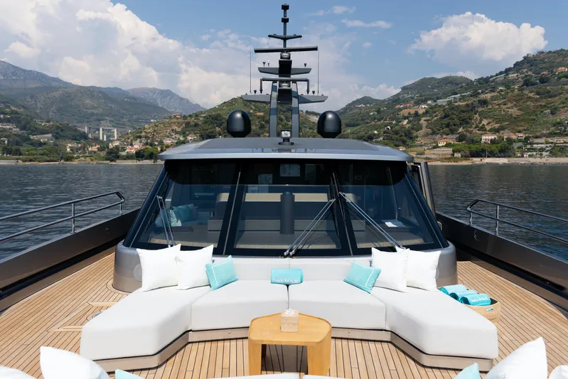 Palmax Yacht Photos Pics Luxurious 2022 Azimut Magellano 30M yacht with elegant deck seating and scenic coastal backdrop.