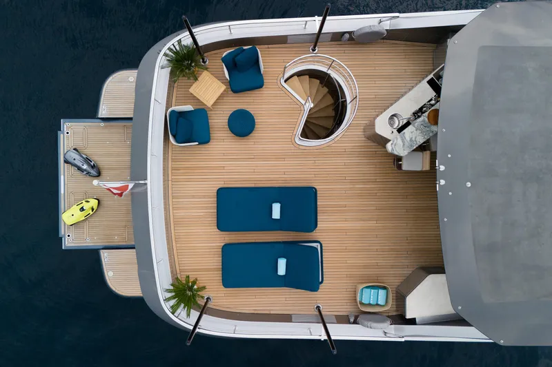 Palmax Yacht Photos Pics Aerial view of 2022 Azimut Magellano 30M yacht deck with seating and spiral staircase.