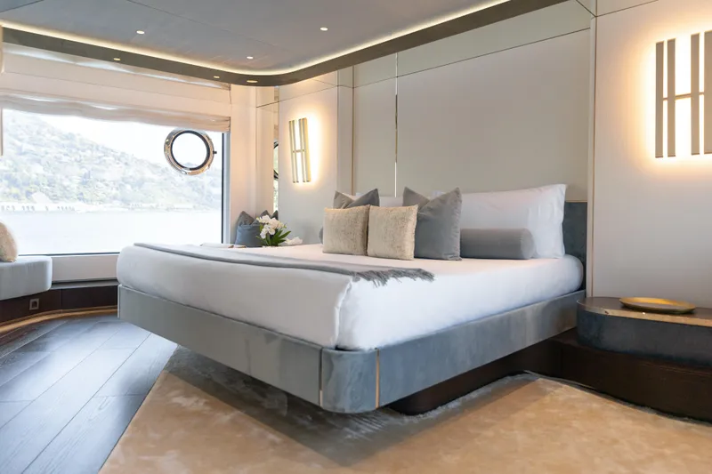 Palmax Yacht Photos Pics Luxurious bedroom interior of 2022 Azimut Magellano 30M yacht with elegant decor and scenic view.