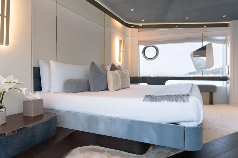 Palmax Yacht Photos Pics Luxurious bedroom interior on 2022 Azimut Magellano 30M yacht, featuring elegant decor and ocean view.