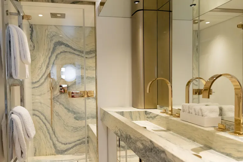 Palmax Yacht Photos Pics Luxurious bathroom in 2022 Azimut Magellano 30M yacht with marble and gold accents.