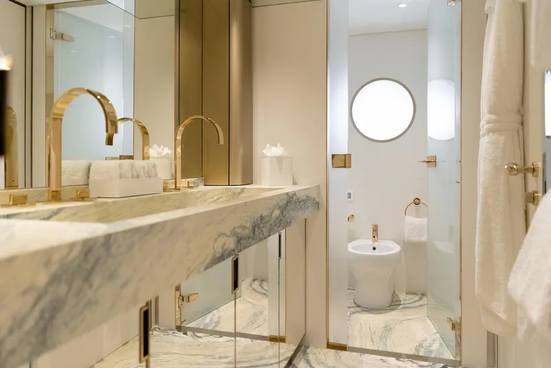 Palmax Yacht Photos Pics Luxurious bathroom on 2022 Azimut Magellano 30M yacht with marble and gold accents.