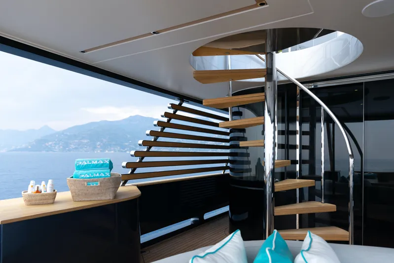 Palmax Yacht Photos Pics Luxurious interior of 2022 Azimut Magellano 30M yacht with spiral staircase and ocean view.