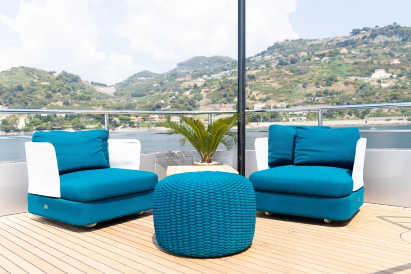 Palmax Yacht Photos Pics Luxurious deck seating on 2022 Azimut Magellano 30M yacht with scenic coastal view.