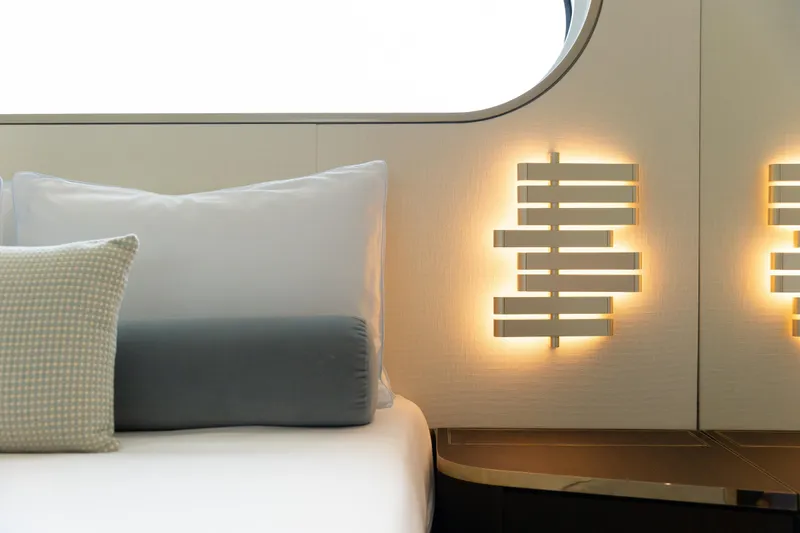 Palmax Yacht Photos Pics Luxurious interior of 2022 Azimut Magellano 30M yacht with modern lighting and plush bedding.