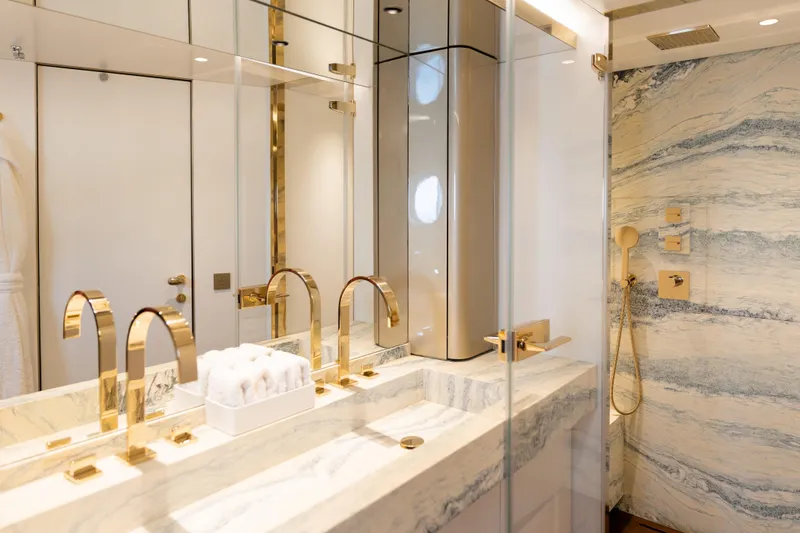 Palmax Yacht Photos Pics Luxurious bathroom on 2022 Azimut Magellano 30M yacht with marble and gold accents.