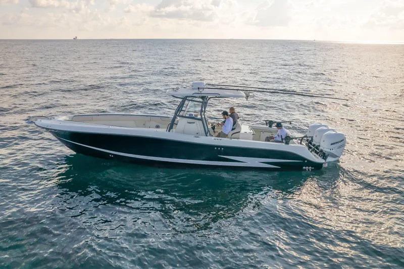  Yacht Photos Pics 2022 Hydra-Sports 3400 boat cruising on open water at sunset.