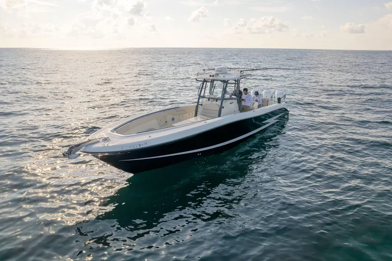  Yacht Photos Pics 2022 Hydra-Sports 3400 boat cruising on open water at sunset.