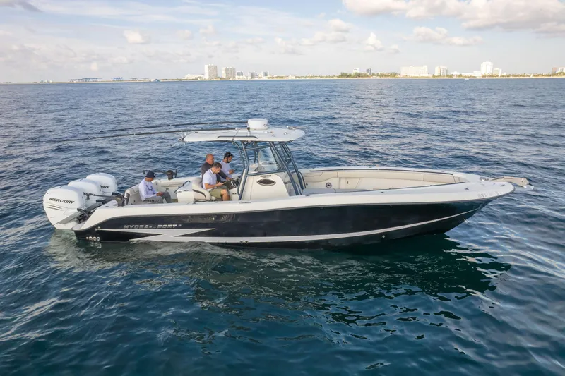  Yacht Photos Pics 2022 Hydra-Sports 3400 boat cruising on open water under a partly cloudy sky.