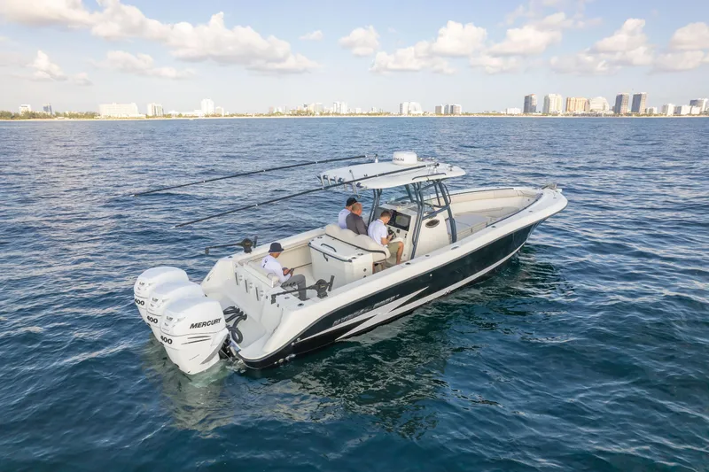  Yacht Photos Pics 2022 Hydra-Sports 3400 boat cruising on open water with city skyline in background.