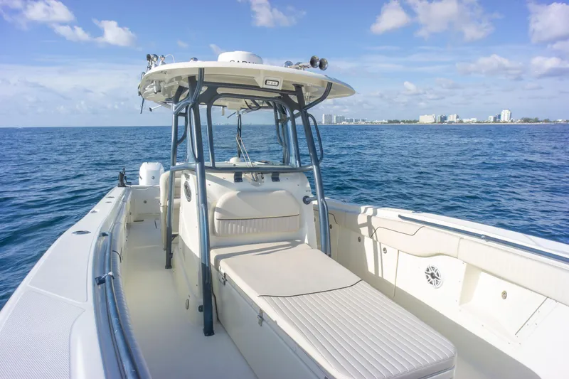  Yacht Photos Pics 2022 Hydra-Sports 3400 boat on open water, clear sky, city skyline in background.