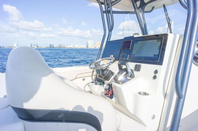  Yacht Photos Pics 2022 Hydra-Sports 3400 boat cockpit with steering wheel and navigation screens, ocean view.