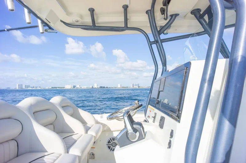  Yacht Photos Pics 2022 Hydra-Sports 3400 boat interior with ocean view, featuring modern seating and navigation equipment.