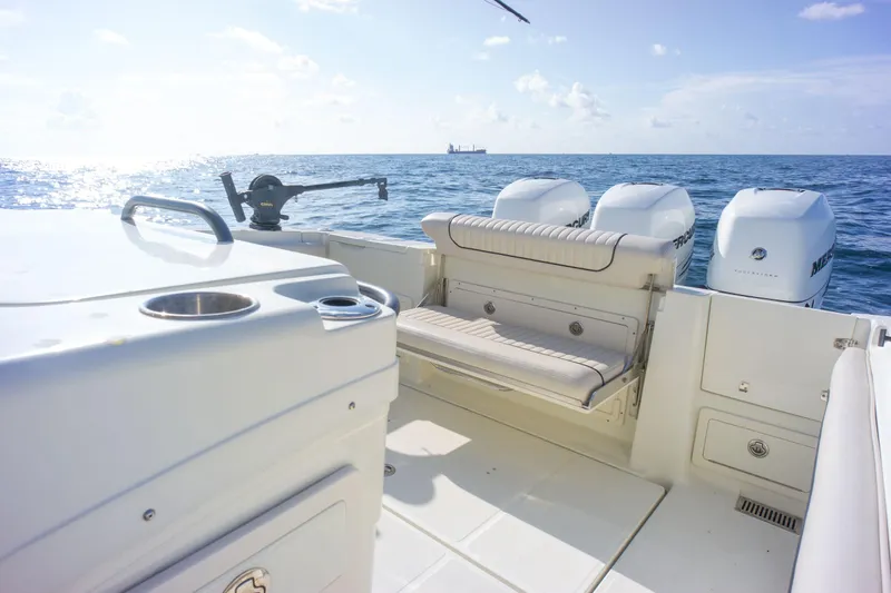  Yacht Photos Pics 2022 Hydra-Sports 3400 boat interior with seating, ocean view, and triple outboard engines.