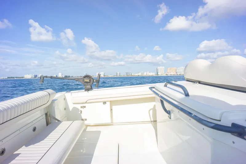  Yacht Photos Pics 2022 Hydra-Sports 3400 boat on open water with city skyline in background.