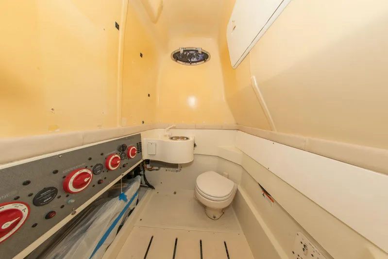  Yacht Photos Pics 2022 Hydra-Sports 3400 boat interior with control panel and compact toilet.